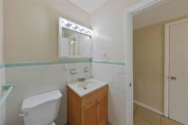 a bathroom with a sink a toilet and mirror