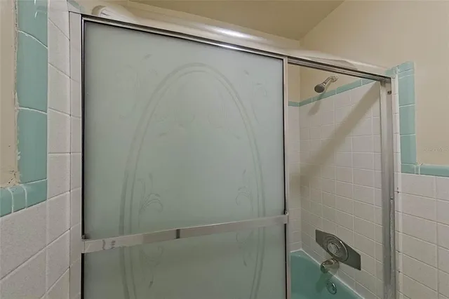 a bathroom with a glass shower door