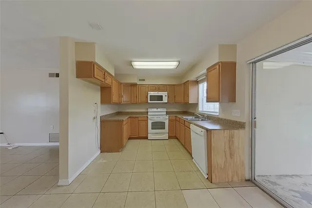 a kitchen with stainless steel appliances granite countertop a stove and a refrigerator