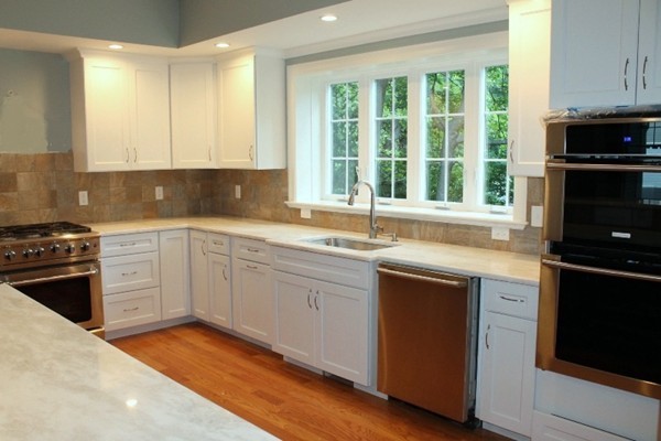 1 Holton Road Lexington, MA 02421 - Photo 7 of 19 a kitchen with a sink stove top oven and cabinets