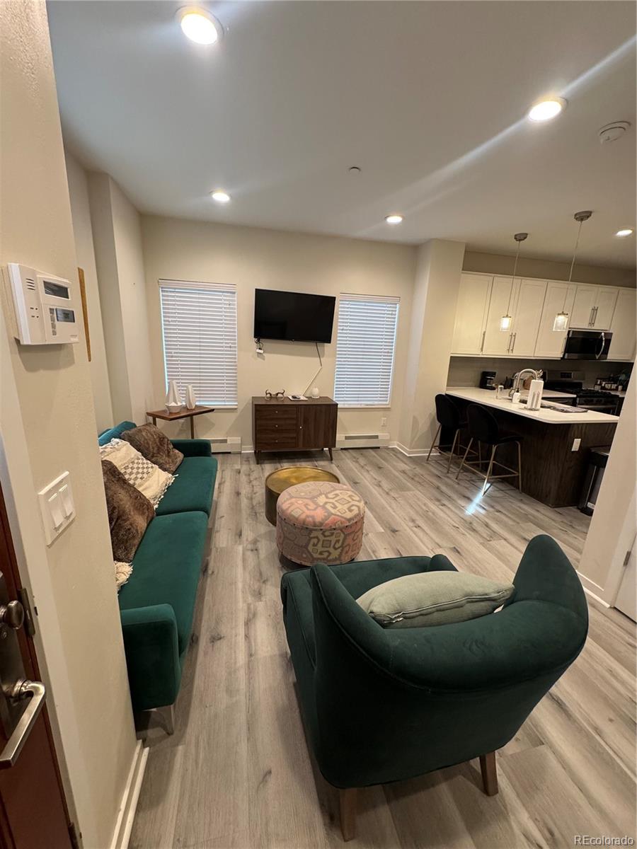2142 Bighorn Road Georgetown, CO 80444 - Photo 18 of 18 a living room with furniture and a wooden floor