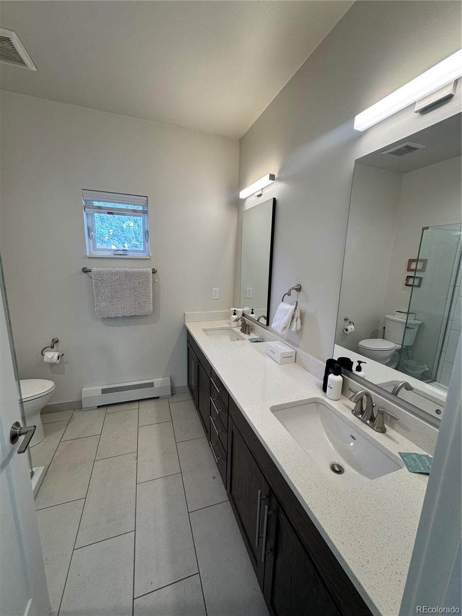 2142 Bighorn Road Georgetown, CO 80444 - Photo 7 of 18 a bathroom with a double vanity sink mirror and toilet