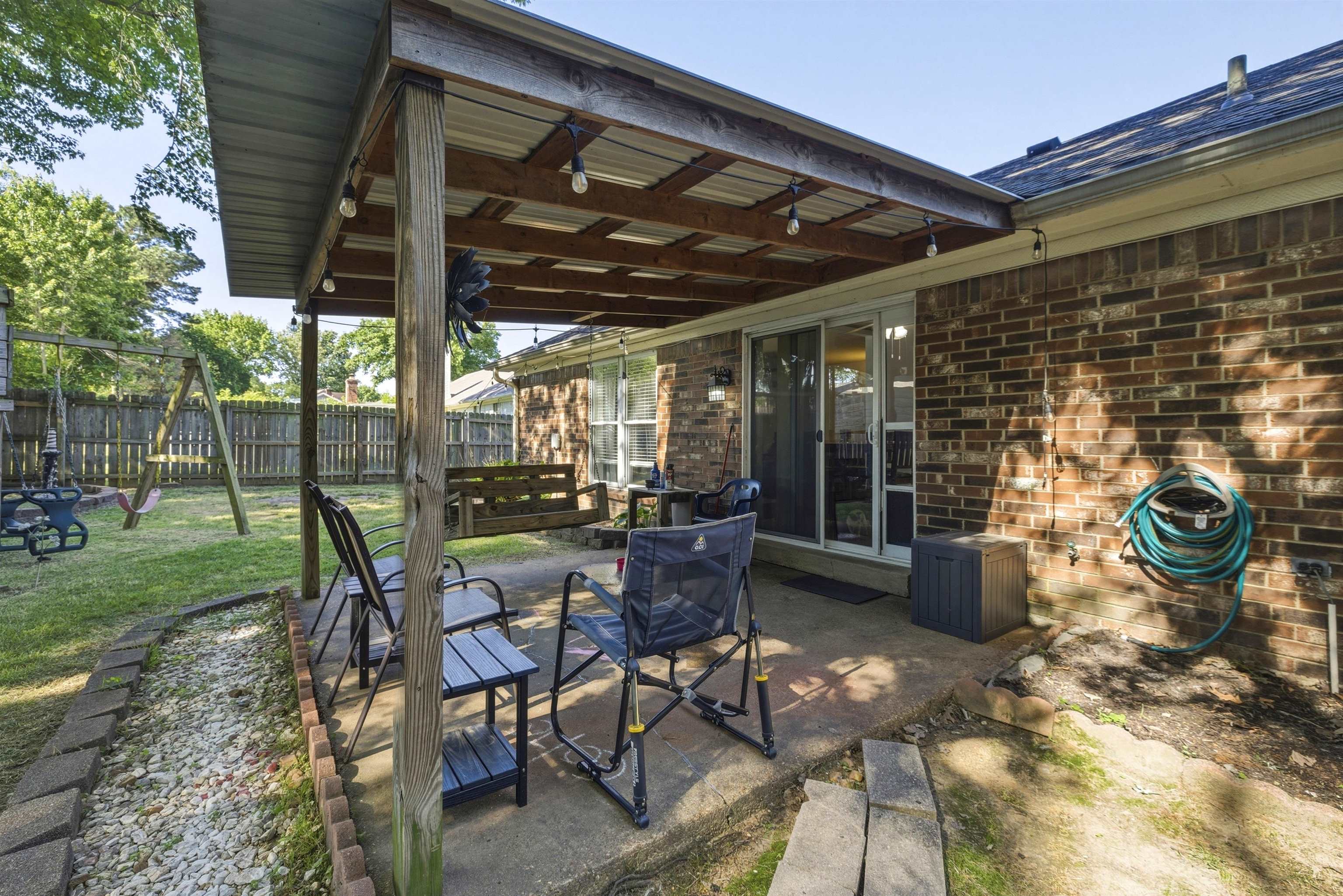 3276 Altruria Road Bartlett, TN 38134 - Photo 22 of 30 Covered patio with a corrugated metal roof, concrete flooring, and string lighting