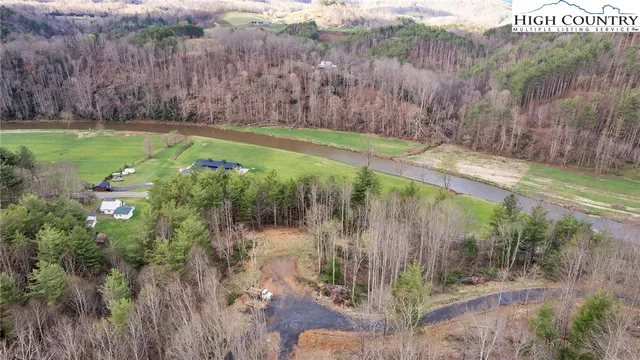 a view of a lush green hillside and a building