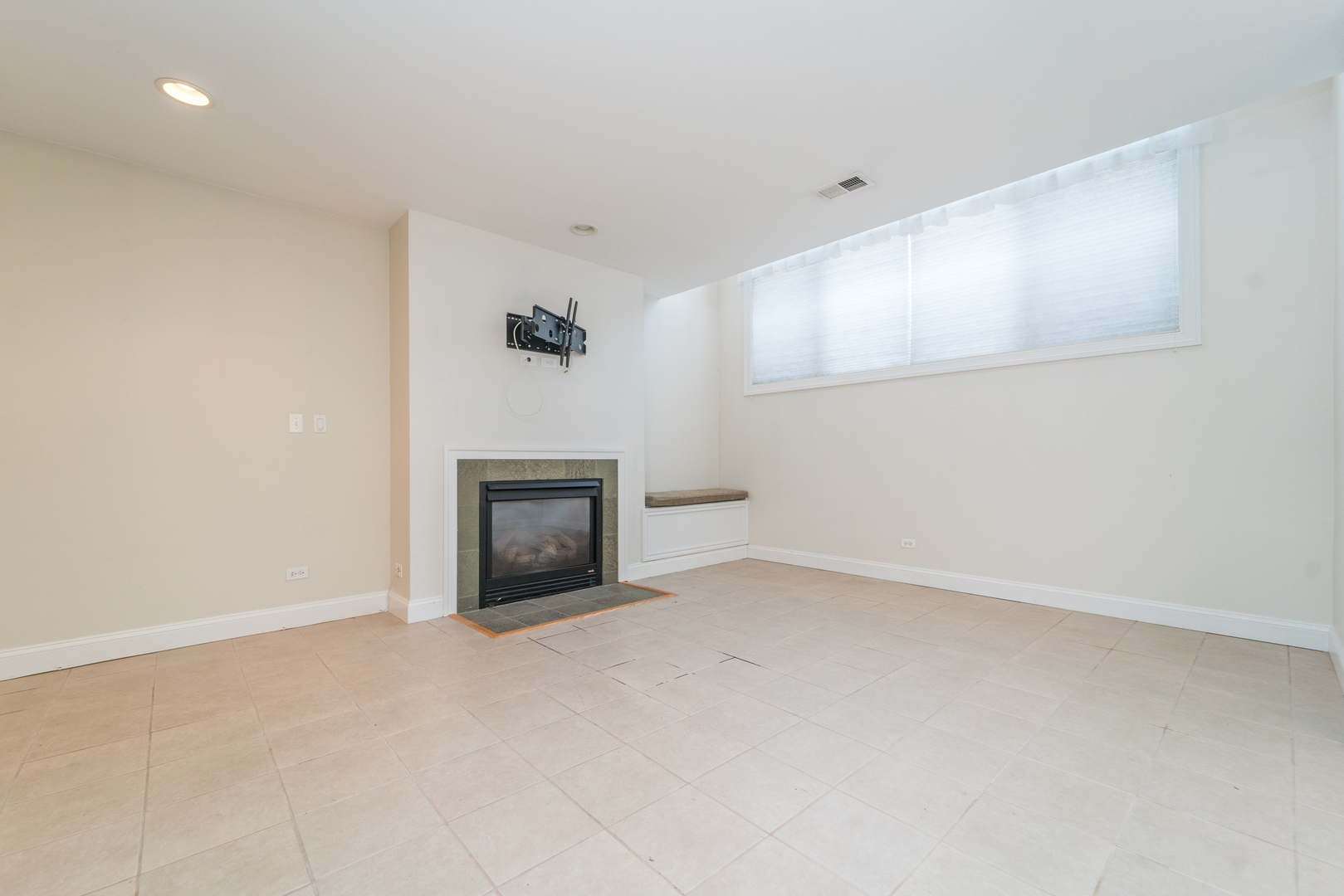 7509 West Irving Park Road, Unit 1 Chicago, IL 60634 - Photo 16 of 28 a view of an empty room with a fireplace