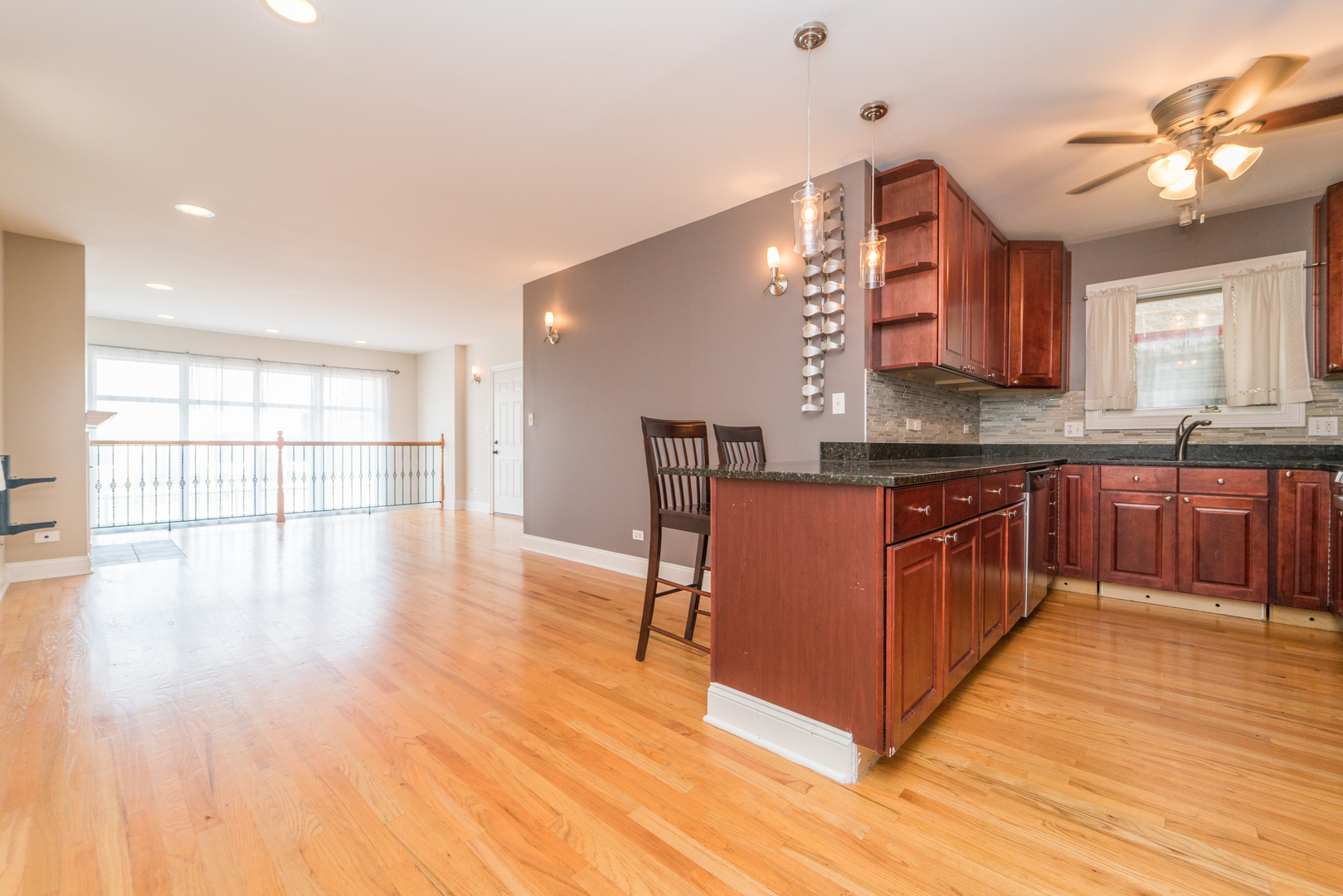 7509 West Irving Park Road, Unit 1 Chicago, IL 60634 - Photo 6 of 28 a kitchen with stainless steel appliances granite countertop a stove cabinets and wooden floor