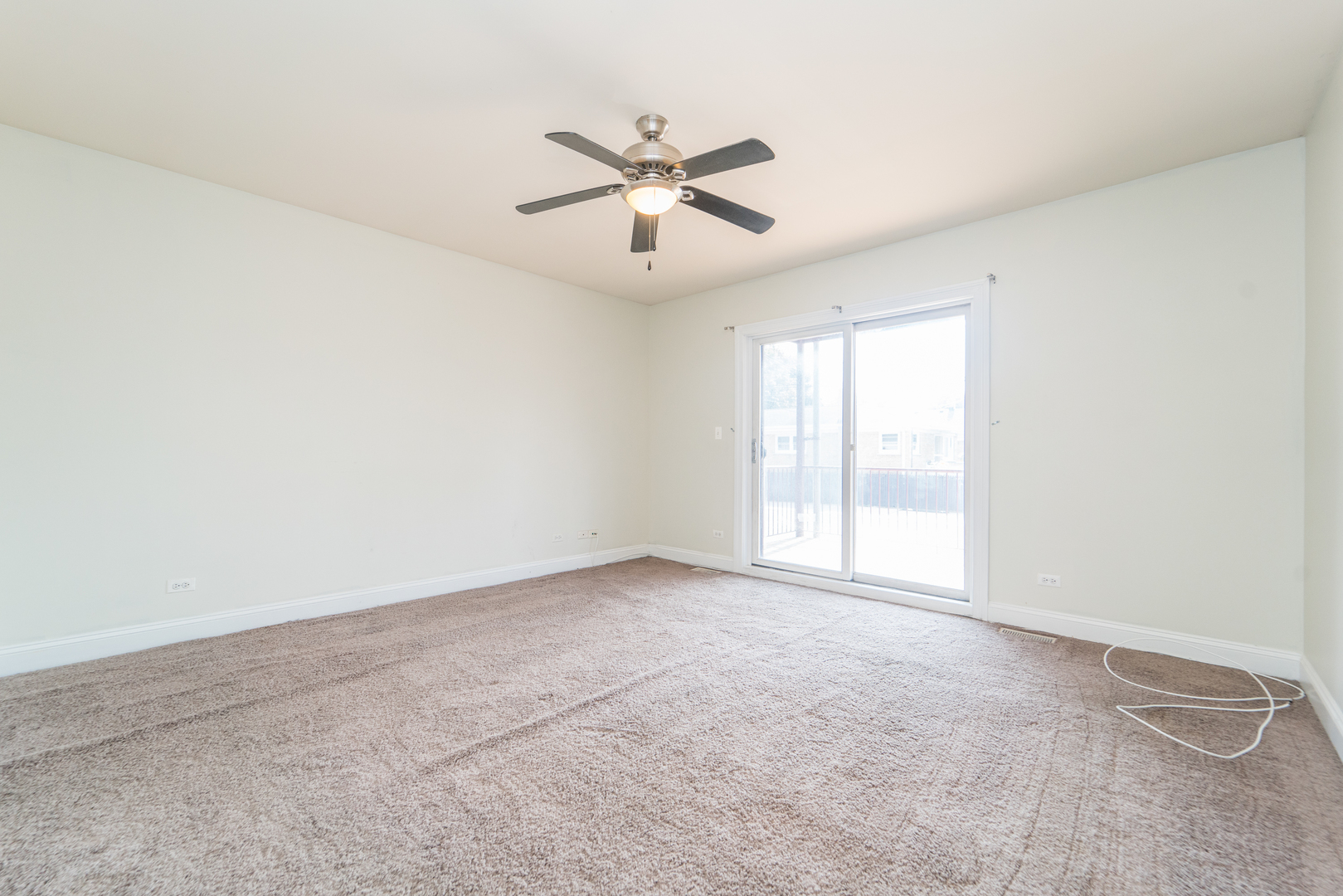 7509 West Irving Park Road, Unit 1 Chicago, IL 60634 - Photo 10 of 28 an empty room with windows and fan