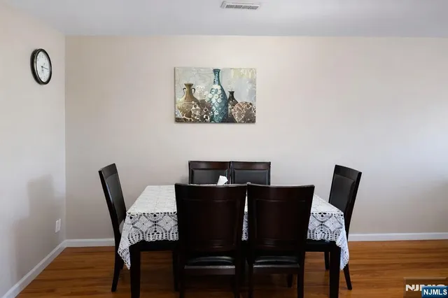 a living room with furniture dining table and wooden floor