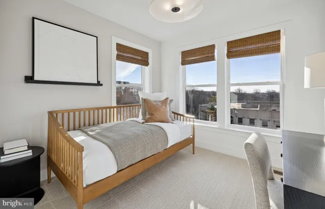 a bedroom with a large bed and a window