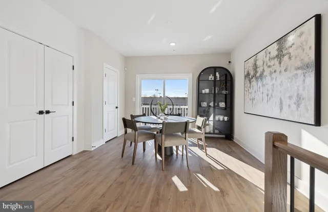 a dining room with furniture and wooden floor