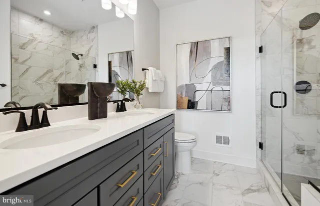 a bathroom with a double vanity sink mirror and shower