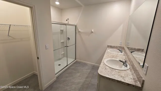 a bathroom with a granite countertop sink and a washing machine