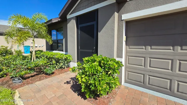 a view of a house with a flower garden
