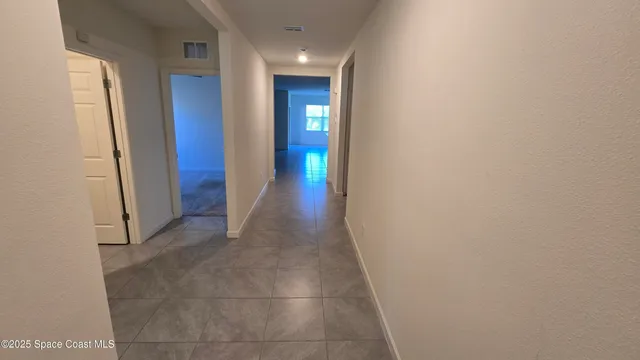 a view of hallway with wooden floor