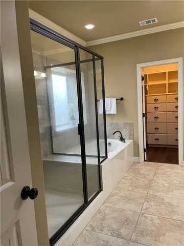 a bathroom with a glass shower door and a sink