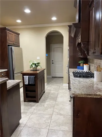 a kitchen with refrigerator and cabinets