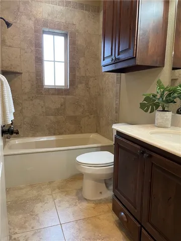 a bathroom with a sink a toilet and bathtub