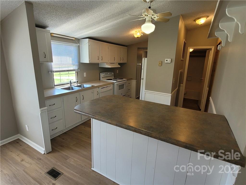 309 Johnson Dairy Road Mooresville, NC 28115 - Photo 2 of 19 a kitchen with stainless steel appliances granite countertop a sink a stove and a refrigerator