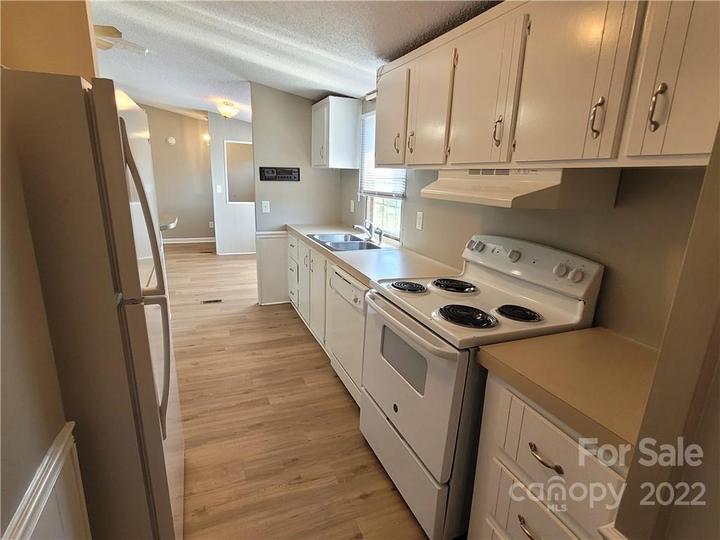 309 Johnson Dairy Road Mooresville, NC 28115 - Photo 3 of 19 a kitchen with sink a refrigerator and cabinets