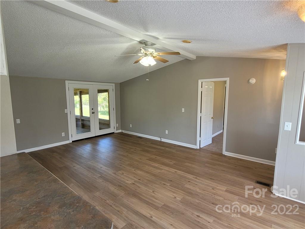 309 Johnson Dairy Road Mooresville, NC 28115 - Photo 5 of 19 a view of an empty room with window and wooden floor