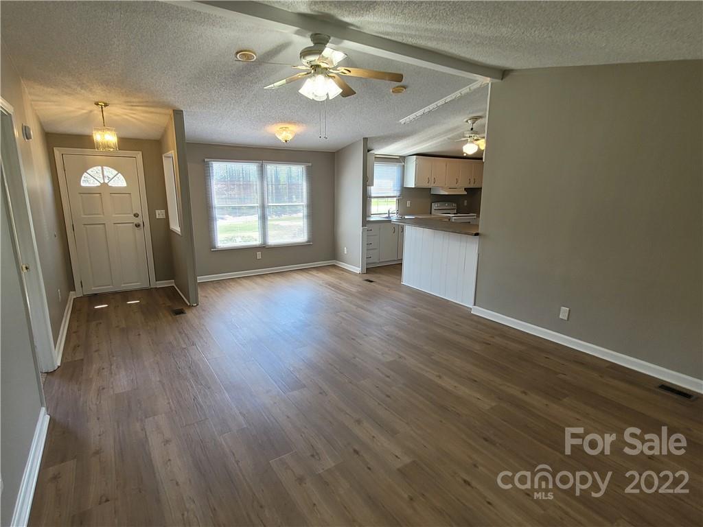 309 Johnson Dairy Road Mooresville, NC 28115 - Photo 6 of 19 wooden floor in an empty room with a window