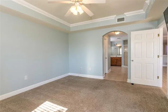a bedroom with a bed and painting on the wall