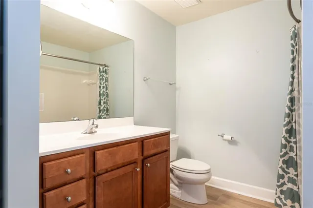 a view of a lake with boats and trees in the background