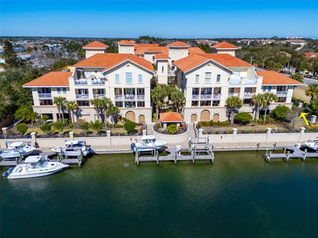 an aerial view of a house with a lake view
