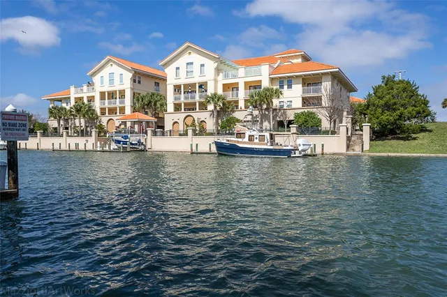 an aerial view of lake and residential houses with outdoor space