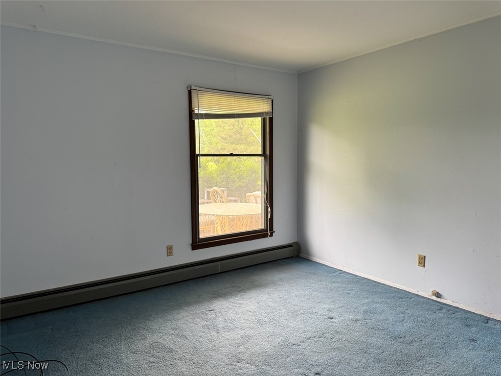 16510 Mock Road Berlin Center, OH 44401 - Photo 21 of 29 Carpeted bedroom with baseboard heating and crown molding