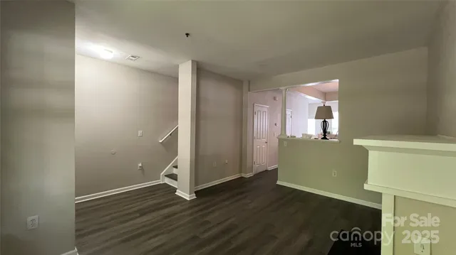 an empty room with wooden floor and a window