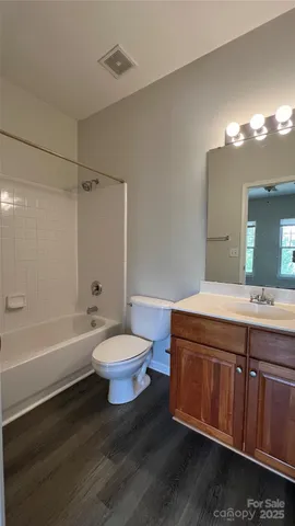 a bathroom with a sink a toilet and bathtub