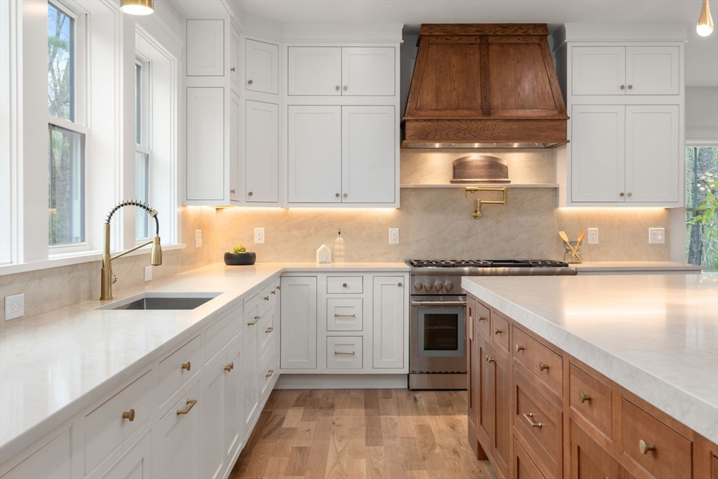 82 Deer Path Lane Weston, MA 02493 - Photo 8 of 42 a kitchen with granite countertop white cabinets and white appliances
