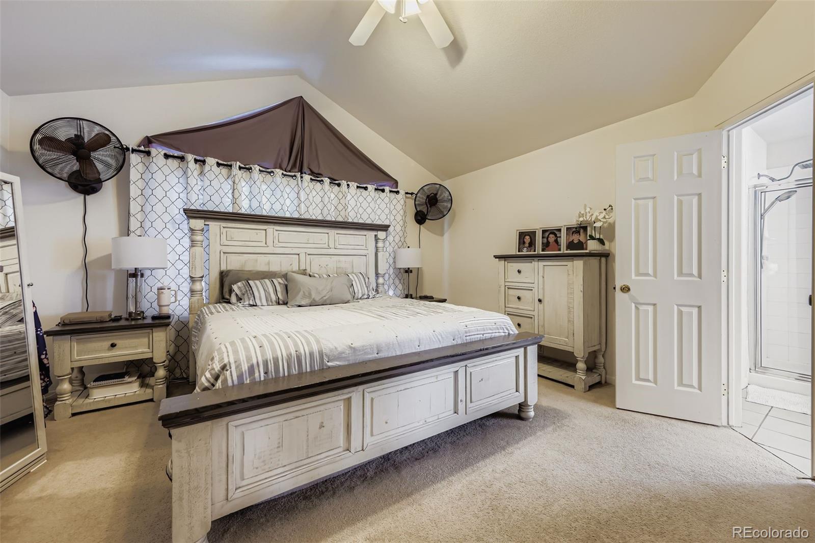 11668 Xavier Way Westminster, CO 80031 - Photo 12 of 22 a bedroom with a large bed and a chandelier