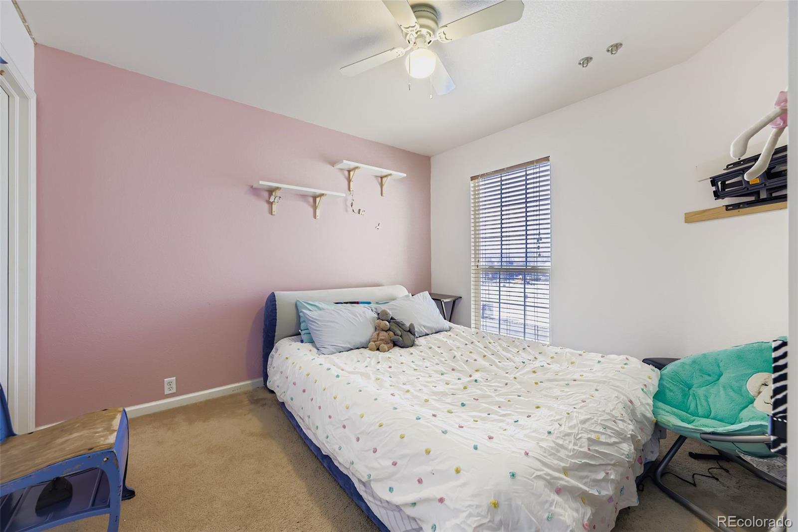 11668 Xavier Way Westminster, CO 80031 - Photo 15 of 22 a bedroom with a bed and a chandelier