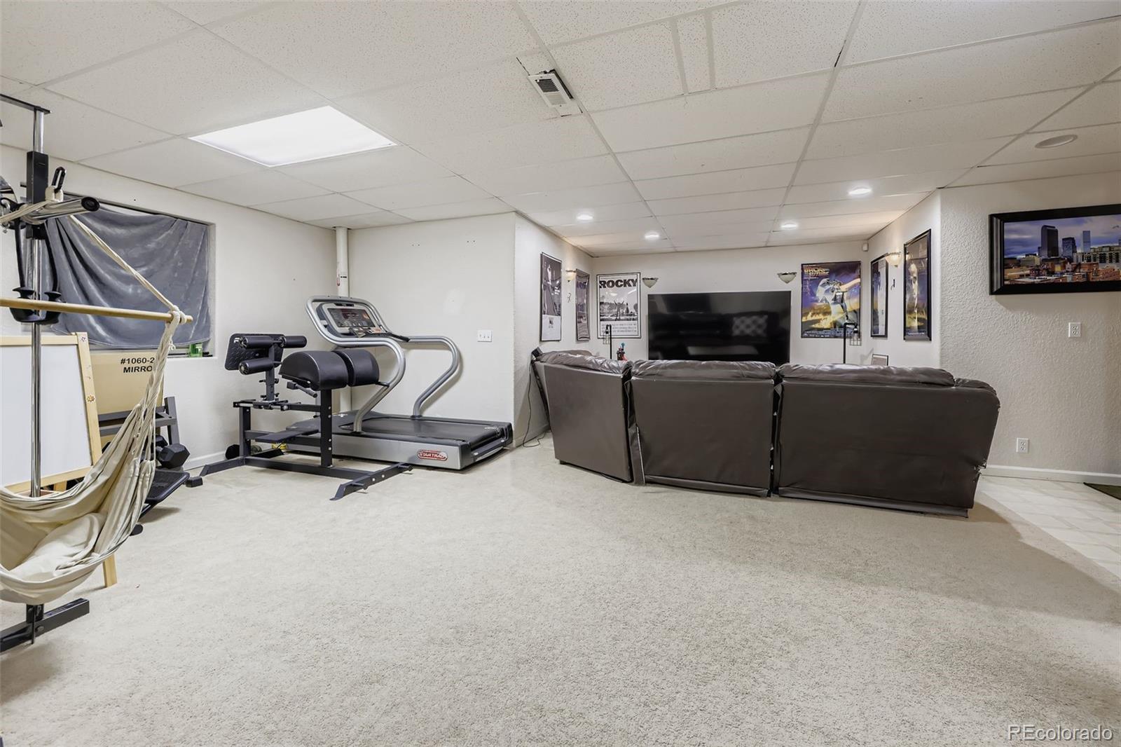 11668 Xavier Way Westminster, CO 80031 - Photo 19 of 22 a view of a livingroom with furniture and a flat screen tv