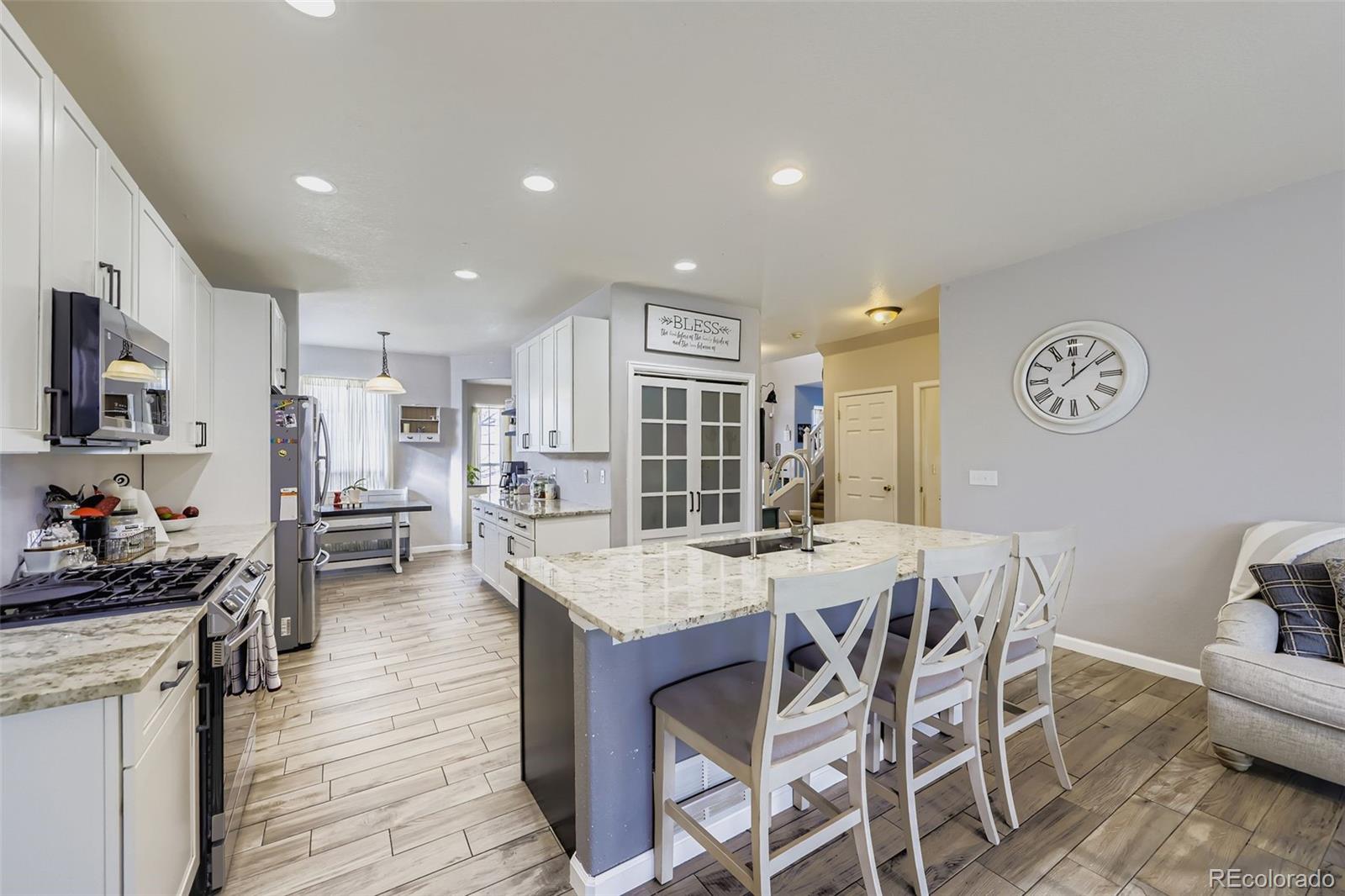 11668 Xavier Way Westminster, CO 80031 - Photo 4 of 22 a view of a dining room with furniture and wooden floor