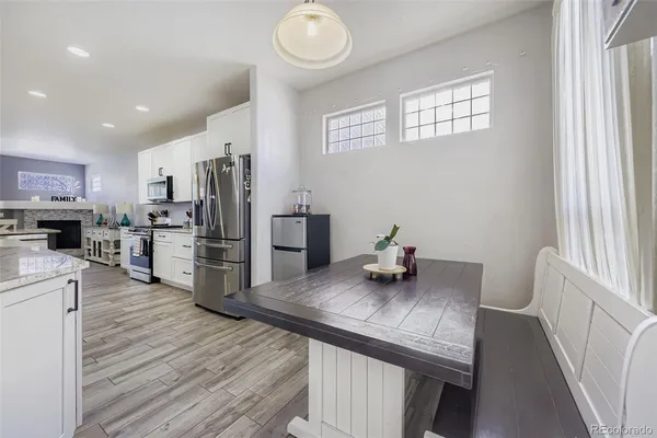 a kitchen with stainless steel appliances granite countertop a refrigerator and microwave