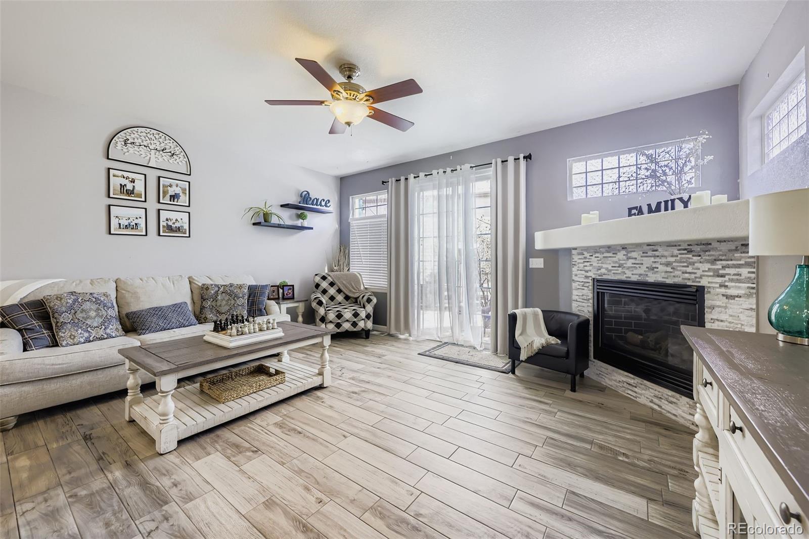 11668 Xavier Way Westminster, CO 80031 - Photo 8 of 22 a living room with furniture and a fireplace