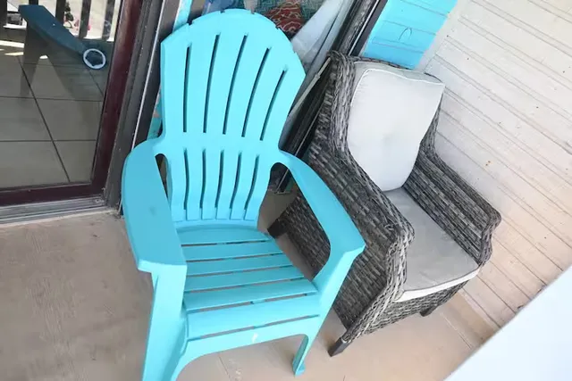 a view of a lake with table and chairs