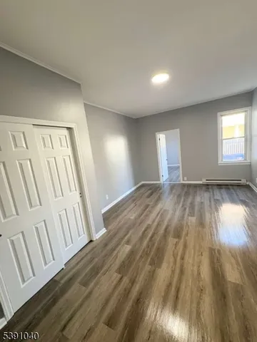 a view of an empty room and wooden floor