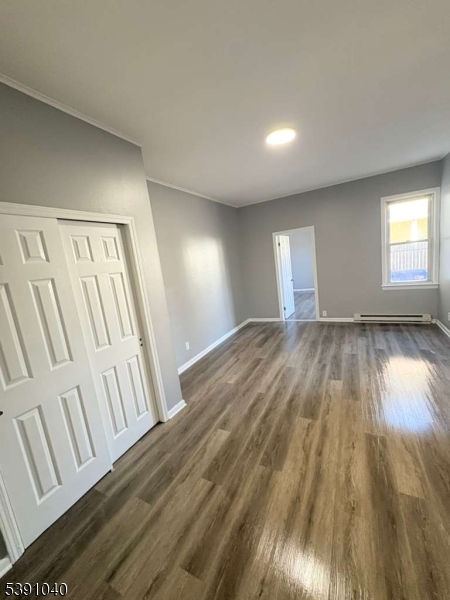 37 Mercer Street, Unit 1 Wallington, NJ 07057 - Photo 12 of 12 a view of an empty room and wooden floor
