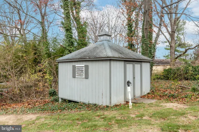 a view of house with yard and green space