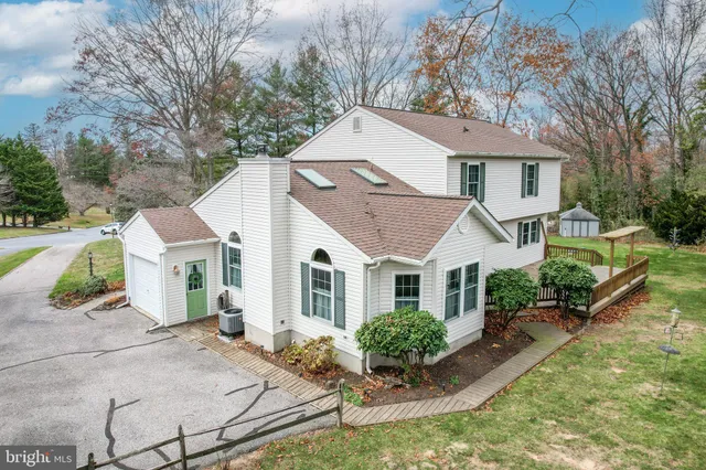a aerial view of a house with a yard and potted plants