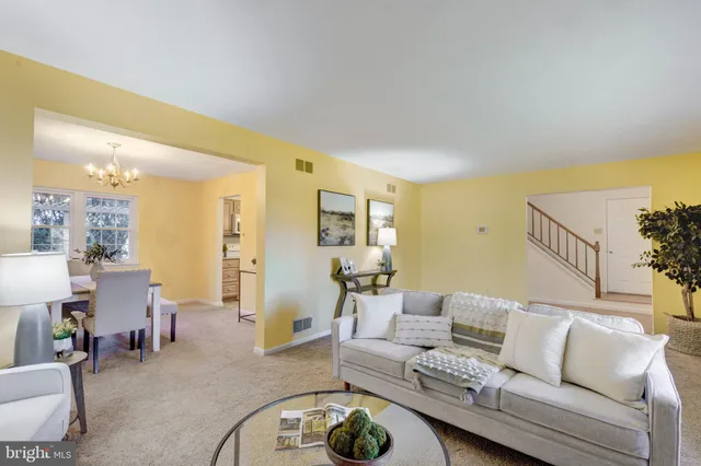 a living room with furniture a rug and a chandelier