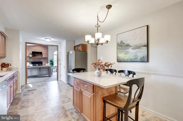 a view of a dining room and a kitchen with a table chairs
