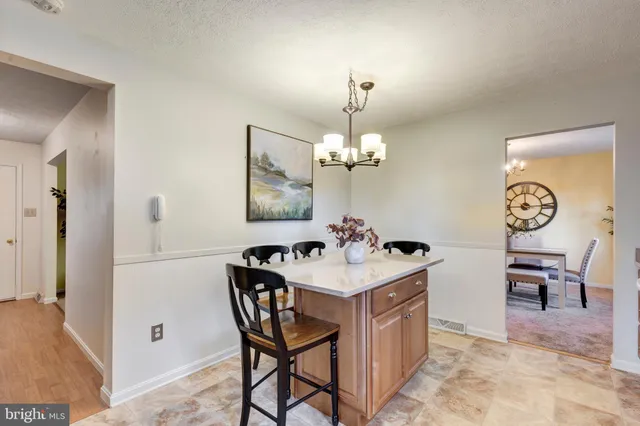 a view of a kitchen area with furniture and chandelier