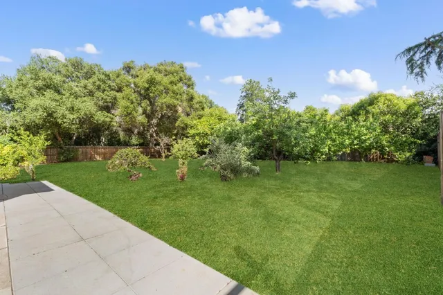 a view of a garden with a building in the background