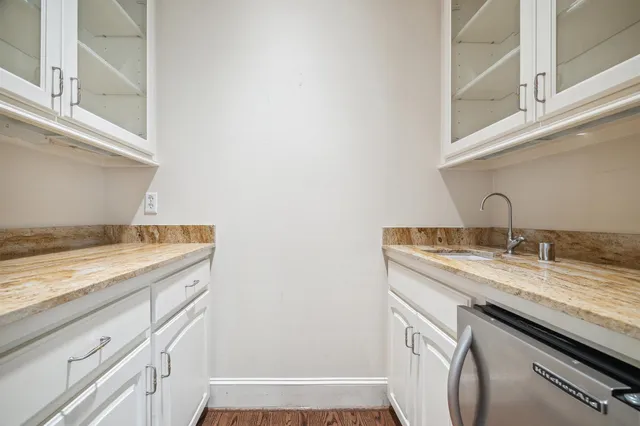 a view of a livingroom with a fireplace a flat screen tv and staircase