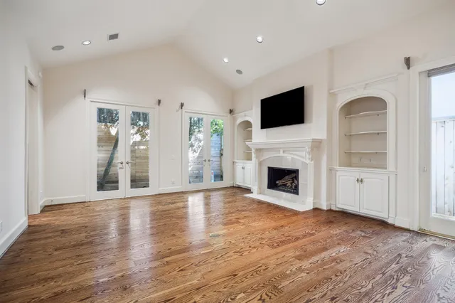 a kitchen with kitchen island granite countertop a sink cabinets and wooden floor